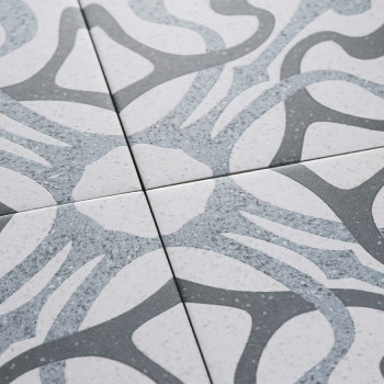 Les carreaux affichent des motifs gris abstraits et courbés sur un fond blanc moucheté, se croisant sur leurs bords pour former 