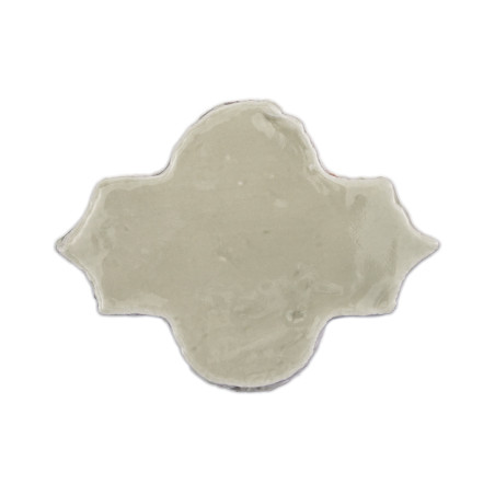 A glazed, light-colored terracotta tile with a quatrefoil shape, appearing against a plain white background.