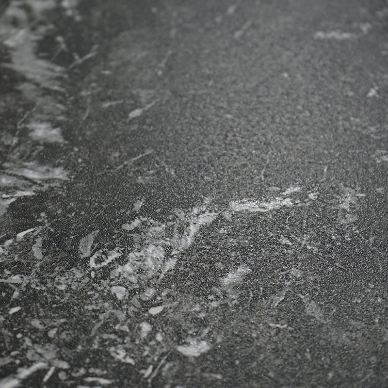 A dark gray tile features a subtle white marbled pattern, creating a sophisticated and textured appearance suitable for modern i
