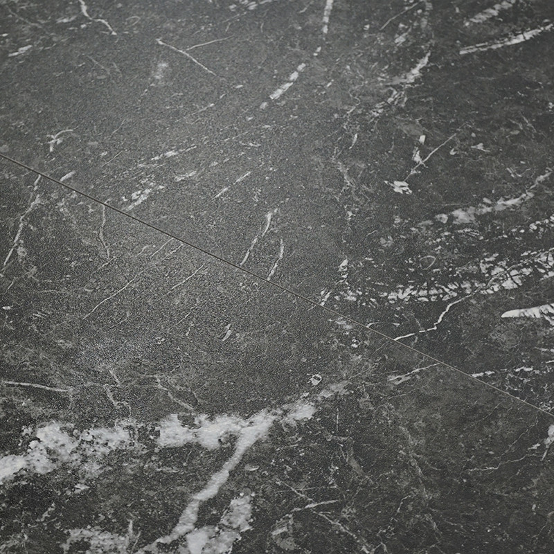 Un azulejo oscuro estilo mármol con vetas blancas. Se coloca paralelo a azulejos similares, creando un patrón de piso elegante y