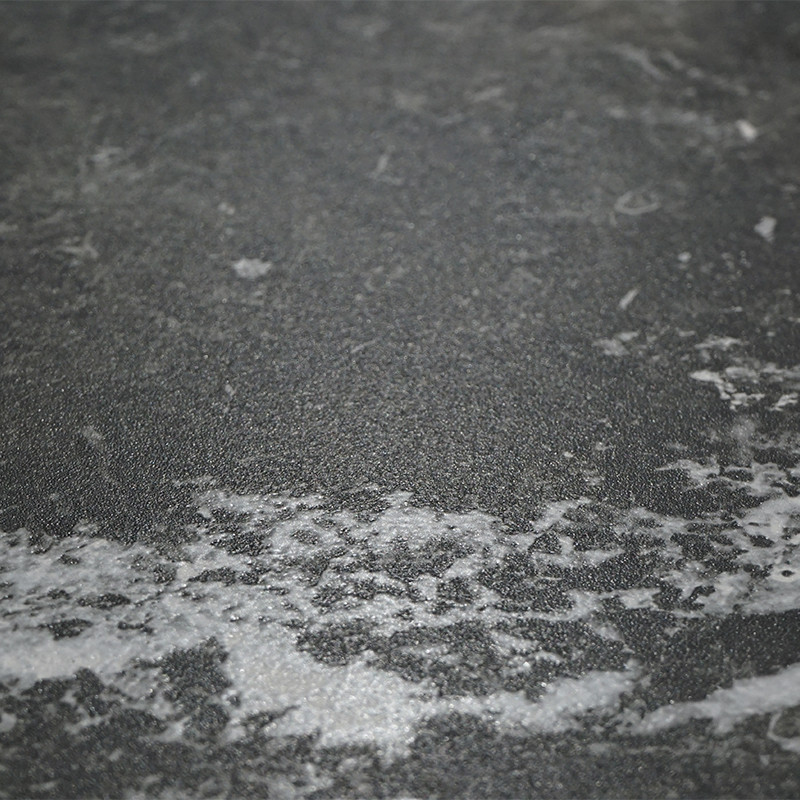 A dark gray tile with white marbled patterns swirls across the surface, creating a textured, stone-like appearance in a flat, sm
