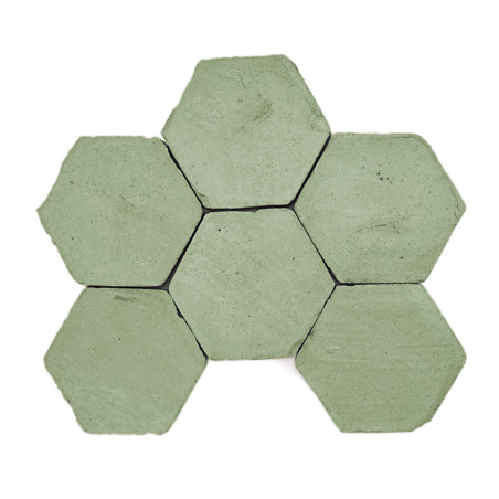 Hexagonal terracotta tiles arranged in a honeycomb pattern, displaying a muted green color, set against a white background.