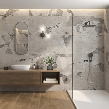 Un baño minimalista cuenta con un tocador de madera con lavabo redondo, un espejo ovalado arriba y una lámpara de pared. Azulejo