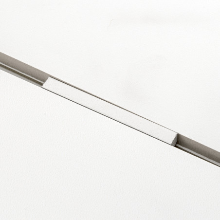 A rectangular white tile rests with a visible separator creating a thin gap, contrasting against a smooth, uniform white backgro