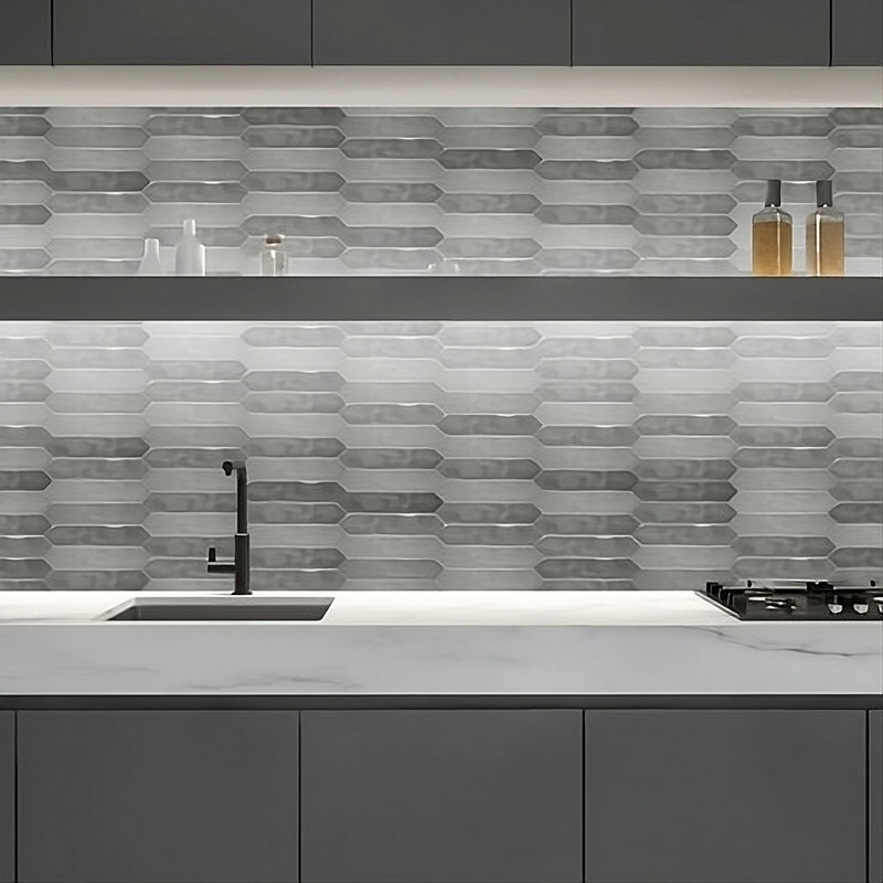 A modern kitchen features elongated hexagonal tiles as backsplash, with a matte black faucet and sink, under soft ambient lighti