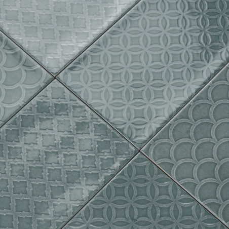 A collection of green tiles displays geometric patterns, including circles, diamonds, and scallops, creating a textured, decorat