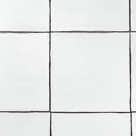 White square tiles arranged in a grid pattern, separated by thin, dark grout lines, form a minimalist wall surface.