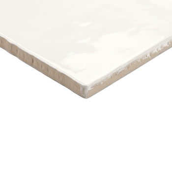 Een vierkante keramische tegel heeft een glanzende, witte afwerking met licht ruwe beige randen, rustend op een effen witte acht