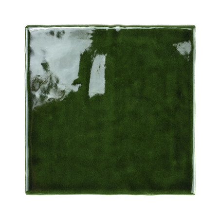 A glossy, dark green ceramic tile reflects light, displaying a smooth, polished surface with slightly wavy edges, set against a 
