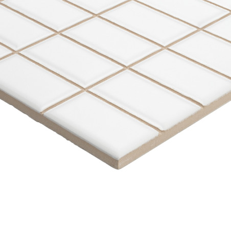 White ceramic tiles, arranged in a grid pattern, rest on a beige base, creating a smooth and uniform surface.