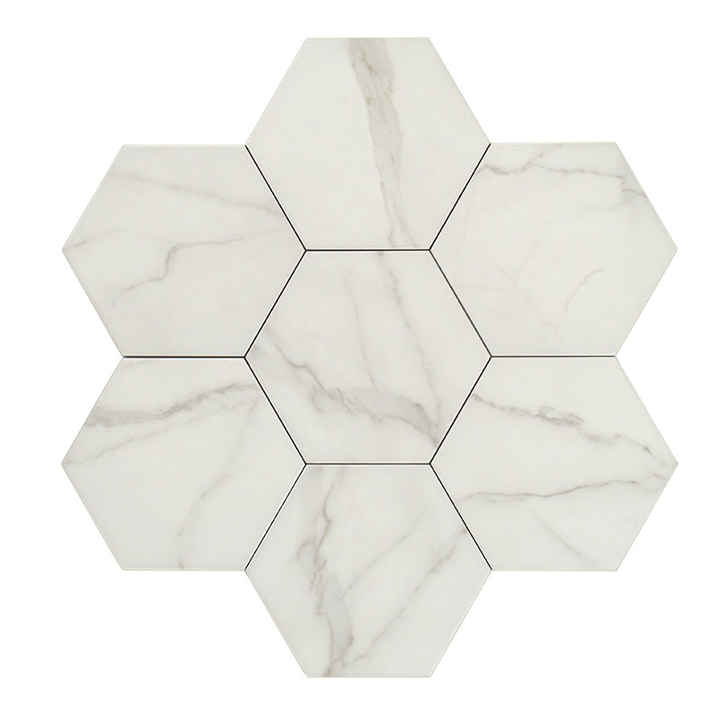 Hexagonal marble tile with soft gray veining, resting against a white background, evoking a clean and modern aesthetic.