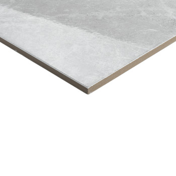Un azulejo plano y rectangular descansa sobre un fondo blanco, con un patrón de mármol gris apagado que agrega una textura sutil