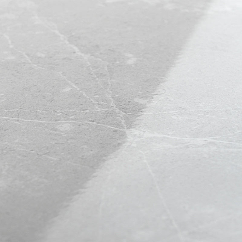 Gray ceramic tile. surface shows fine white veining patterns. glossy finish enhances a smooth texture. set in a neutral indoor e