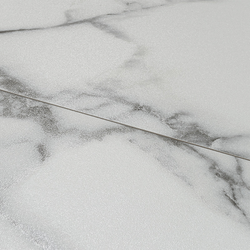 White marble-like tile with gray veins and a slightly glossy surface; thin diagonal joint and continuous marbled pattern that suggests adjacent tiles.