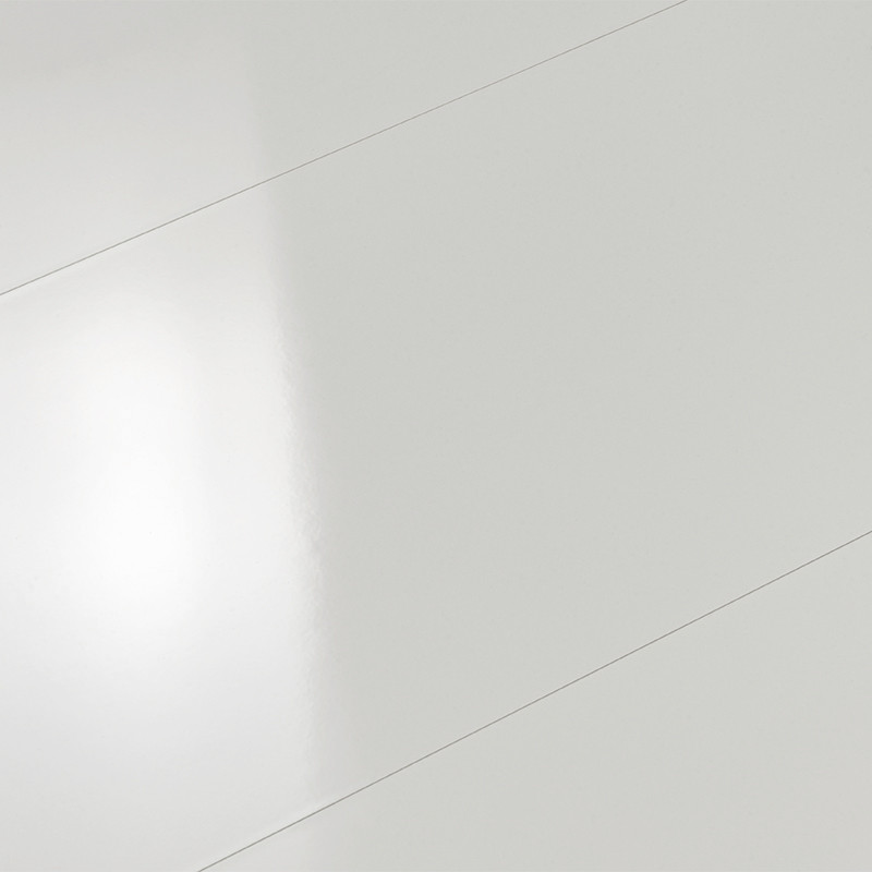 Bright white tile with a smooth surface reflecting light, thin diagonal joint lines; indistinct environment suggested by a soft reflection on the surface.