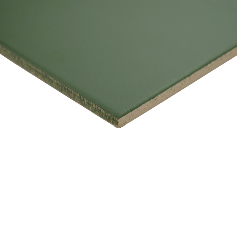Matte green rectangular tile, exposed edge and core, shown at an angle that highlights its thickness, placed on a clear white background.