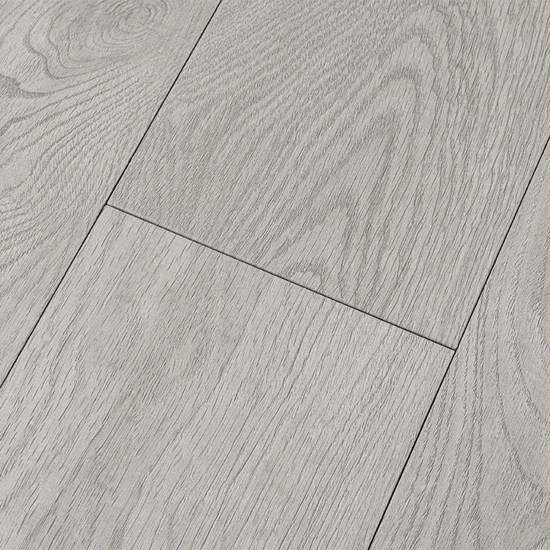 Carrelage imitation bois: planches rectangulaires gris clair, veinures apparentes, joints fins et réguliers, posées côte à côte sur un sol intérieur.