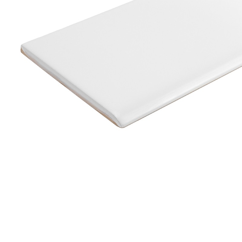 White glazed rectangular tile with beveled edge; seen in perspective, isolated on white background, showing corner and thin unglazed edge.