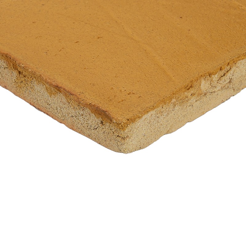 Rectangular terracotta tile, smooth yellowish surface and beveled edge; shows cross-section and porous texture, presented on a neutral white background.